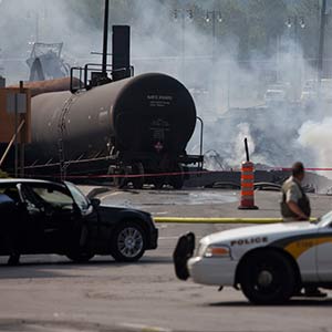 Firefighters continue to douse burning wreckage on July 7, 2013 after a freight train loaded with oil derailed July 6 in Lac-Megantic in Canada's Quebec province (François Laplante-Delagrave/AFP/Getty Images)